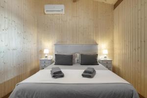 a bedroom with a bed with two towels on it at Villa Fatema in Conil de la Frontera +25 photos