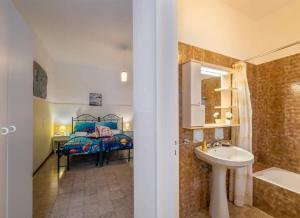 a bathroom with a sink and a bed in a room at Villa Tramonto Ionico Torre Lapillo in Torre Lapillo +22 photos