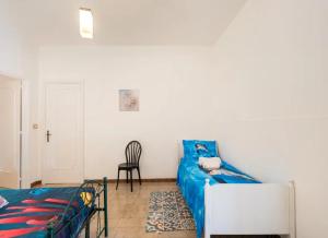 a living room with a blue couch and a chair at Villa Tramonto Ionico Torre Lapillo in Torre Lapillo