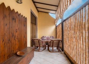 a patio with a table and chairs on a balcony at Villa Tramonto Ionico Torre Lapillo in Torre Lapillo