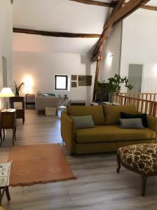 a living room with a couch and a table at Chambre d'hôtes - Els Pomers in Soubrebost