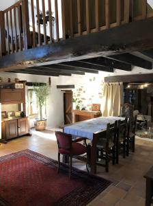 a dining room with a table and chairs at Chambre d'hôtes - Els Pomers in Soubrebost