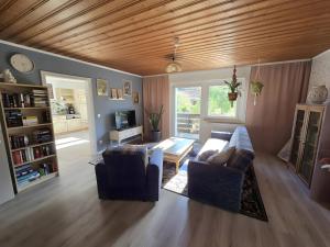 a living room with two chairs and a table at Regenhäusl Waldbach in Arrach