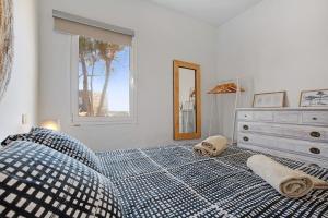 a bedroom with a bed with a dresser and a window at El Cotillo Mar Sea View in El Cotillo