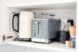 a appliance sitting on a shelf in a kitchen at Zuhause am Kurgarten in Bad Reichenhall