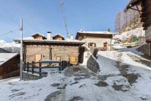 a small wooden building with snow on the ground at Chalet di Mont in Valfurva