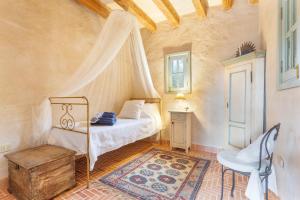 a bedroom with a bed and a chair in a room at Oasis San Martin El Cotillo in El Cotillo