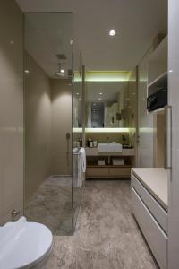 a bathroom with a shower and a toilet and a sink at Eastin Residences Vadodara in Vadodara