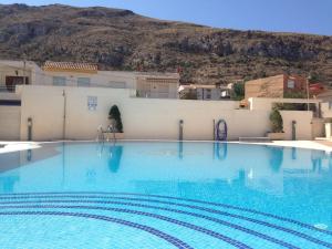 a large swimming pool with a mountain in the background at La Azohía Espacio en Calma in La Azohía