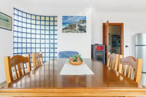 a dining room table with a bowl of fruit on it at La Pineta in SantʼAntìoco