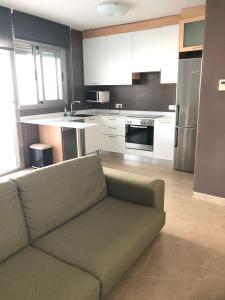 a living room with a couch in a kitchen at La Azohía Espacio en Calma in La Azohía