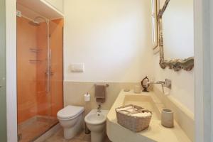 a bathroom with a toilet and a shower and a sink at Villa Dina in Nardò +35 photos