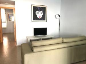 a living room with a couch and a flat screen tv at La Azohía Espacio en Calma in La Azohía