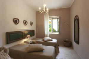 a bedroom with two beds and a window at Villa Dina in Nardò