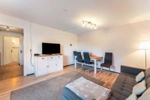 a living room with a couch and a table with chairs at Insel Koje 1-1 in Fehmarn
