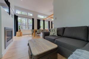 a living room with a couch and a table at La Relache - Nature & Relaxation - Pet Friendly in Pont-Rouge