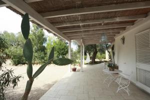 a porch of a house with a wooden roof at Villa Dina in Nardò