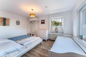 a bedroom with two beds and a window at Insel Koje 1-1 in Fehmarn