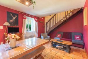 a living room with a couch and a table at Gite Dans Grange Foraine - Baou in Artalens-Souin