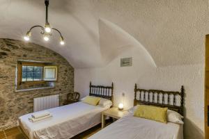 two beds in a room with an attic at Mas Cases in Girona