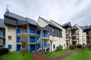 a row of apartment buildings with blue balconies at Le Sailing,parking, proche plage in Arzon