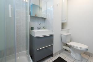 a bathroom with a toilet and a sink and a shower at Le Sailing,parking, proche plage in Arzon +16 photos