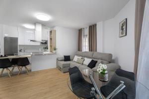 a living room with a couch and a table at Apartamento Calecampo in Candelaria +16 photos