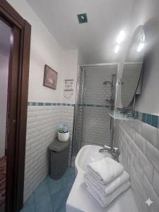 a white bathroom with a sink and a mirror at Casa di Mà Varazze in Varazze