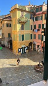 a person standing in front of a large building at Casa di Mà Varazze in Varazze