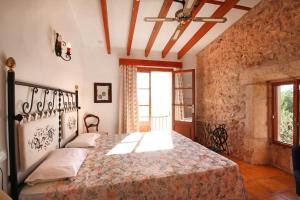 a bedroom with a bed in a room at S'hort des Cura in Islas Baleares +15 photos