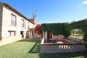 a courtyard of a house with a table and chairs at S'hort des Cura in Islas Baleares