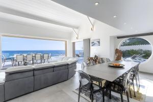 a dining room with a couch and a table at Villa Baraka in Sainte-Maxime