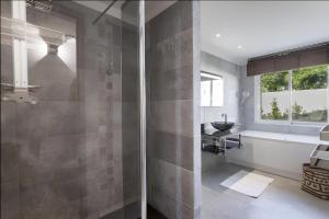 a bathroom with a shower with a glass door at Villa Baraka in Sainte-Maxime +25 photos