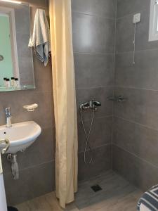 a bathroom with a shower and a sink at Evgenia Rooms in Skala +64 photos