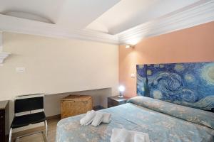 a bedroom with two beds and a painting on the wall at Buddha, borgo dei pescatori in Cervo