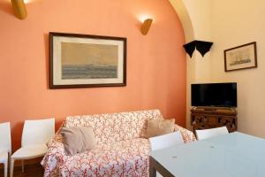 a living room with a couch and a tv at Buddha, borgo dei pescatori in Cervo