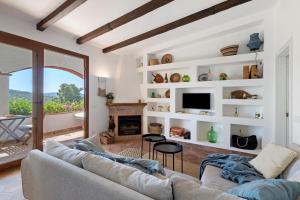a living room with a couch and a fireplace at Praga 2 in Pals