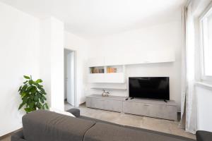 a living room with a couch and a television at Appartamenti Dama 1 in Bardolino