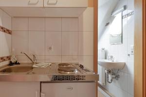 a small kitchen with a sink and a stove at Wein- Und Obstbau Rupp in Obersulm +63 photos