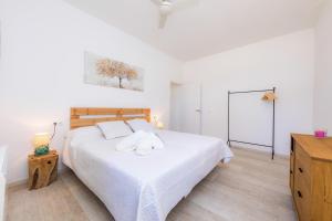 a bedroom with a large white bed and a dresser at Son Crespi Vell in Manacor +17 photos