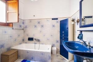 a bathroom with a tub and a sink at Salento Home in Cursi +17 photos