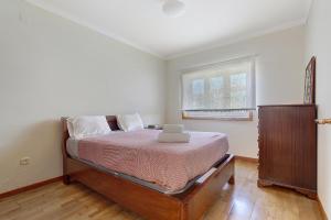 a bedroom with a bed and a window at Dunas Das Marinhas in Marinhas +18 photos