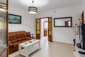 a living room with a couch and a table at Cas Llimoner in Palma de Mallorca
