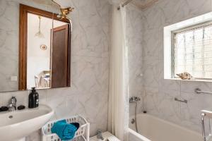 a bathroom with a white tub and a sink at Cas Llimoner in Palma de Mallorca +17 photos