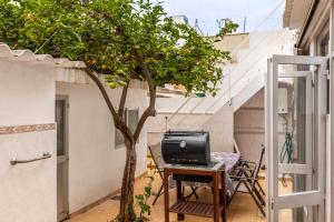 a small tree sitting on a table next to a house at Cas Llimoner in Palma de Mallorca