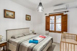 a bedroom with a bed with two pillows on it at Cas Llimoner in Palma de Mallorca