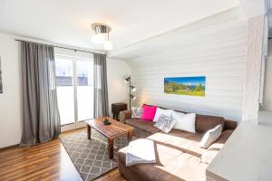 a living room with a couch and a table at Ferienwohnung Rambold Sonnenterrasse in Garmisch-Partenkirchen