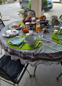 a table with a table cloth with food on it at Mas de Maussan in Robion en Luberon