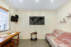 a living room with a couch and a table at Tour House in Rio Tinto