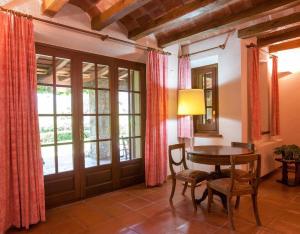 a dining room with a table and a window at Gran Castanyer in Viladrau